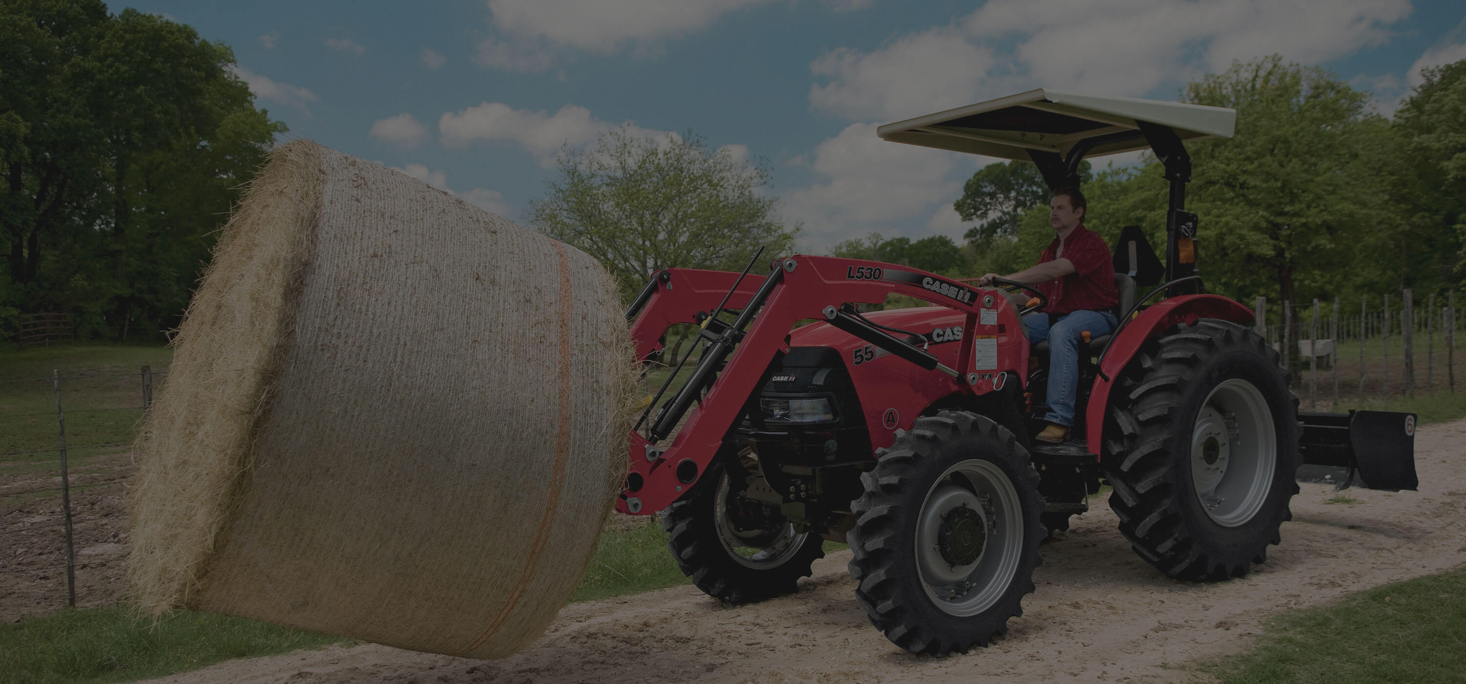 Case IH loading hay bale